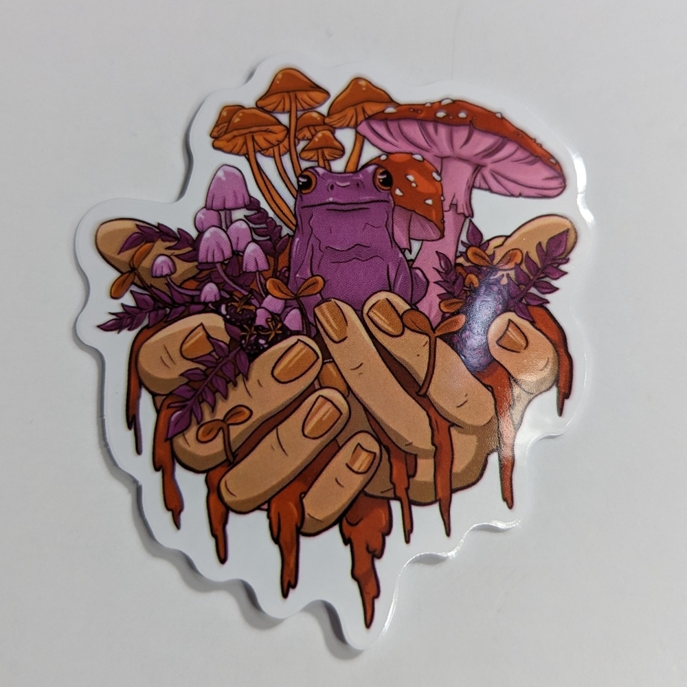 Frog with mushrooms and hands Sticker